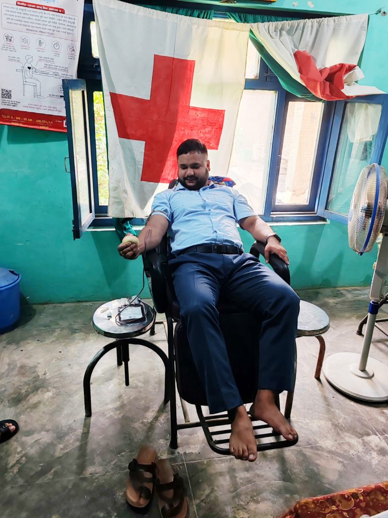 Suresh Giri, O-negative blood donor, smiling after donating blood to help save lives.